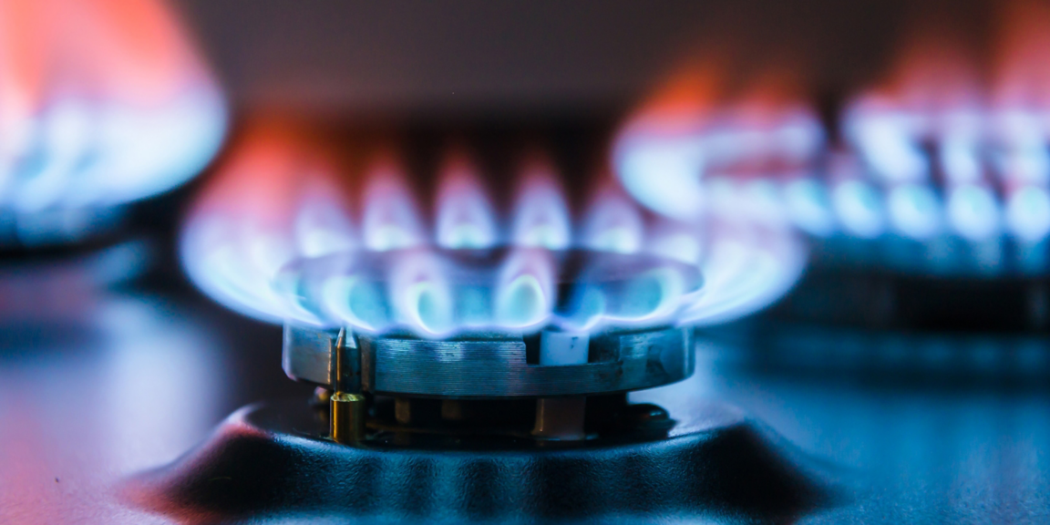 Close-up of a gas burner producing a clean blue flame, highlighting efficient combustion, precise fuel control, and optimized energy performance.