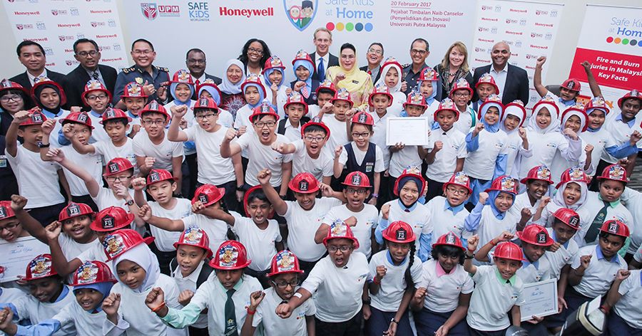 A large group of children and adults participating in a safety awareness program, promoting fire safety education, community engagement, and public safety initiatives.