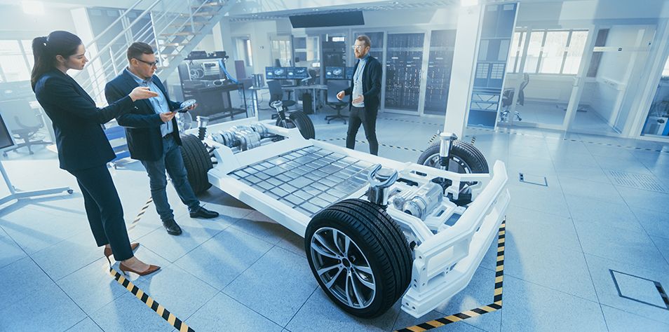 Automotive Design Engineer Shows the Electric Car Chassis Prototype to the Management Board Representatives. Concept Includes Wheels, Hybrid Engine and Battery.