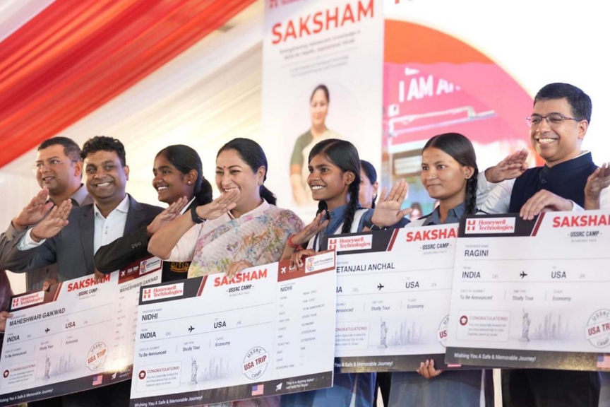 Participants proudly display certificates for the Saksham program, celebrating their journey to the USA.
