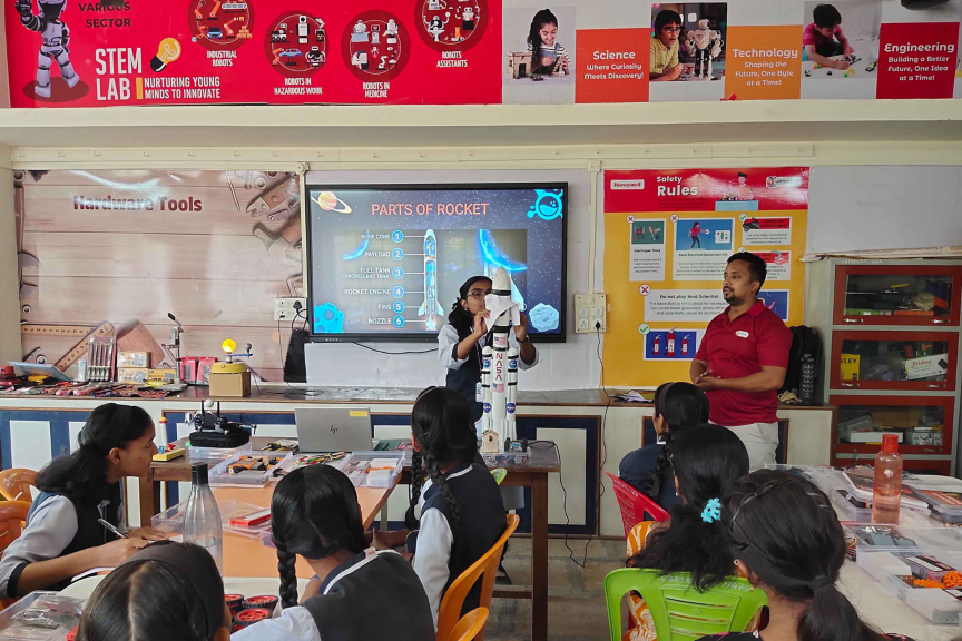 Students in a STEM lab engage in a hands-on lesson about rocket parts, enhancing their science knowledge.