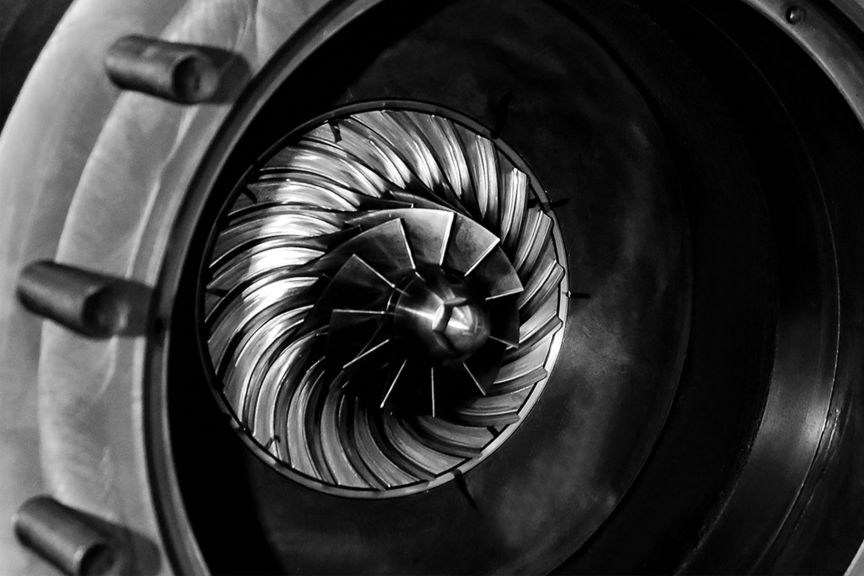 Close-up view of industrial turbomachinery impeller blades, showcasing precision engineering and high-performance rotating equipment.