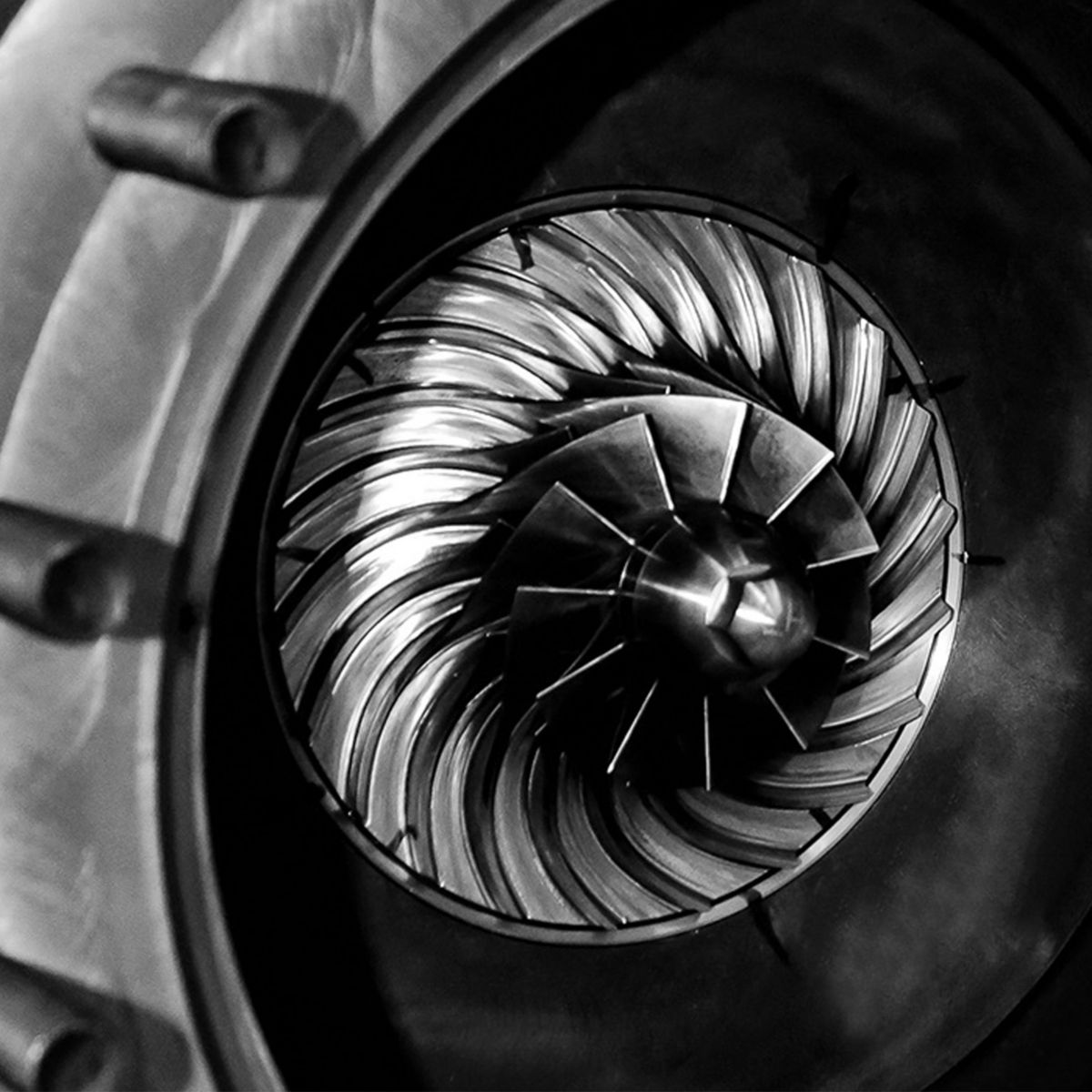 Close-up view of industrial turbomachinery impeller blades, showcasing precision engineering and high-performance rotating equipment.
