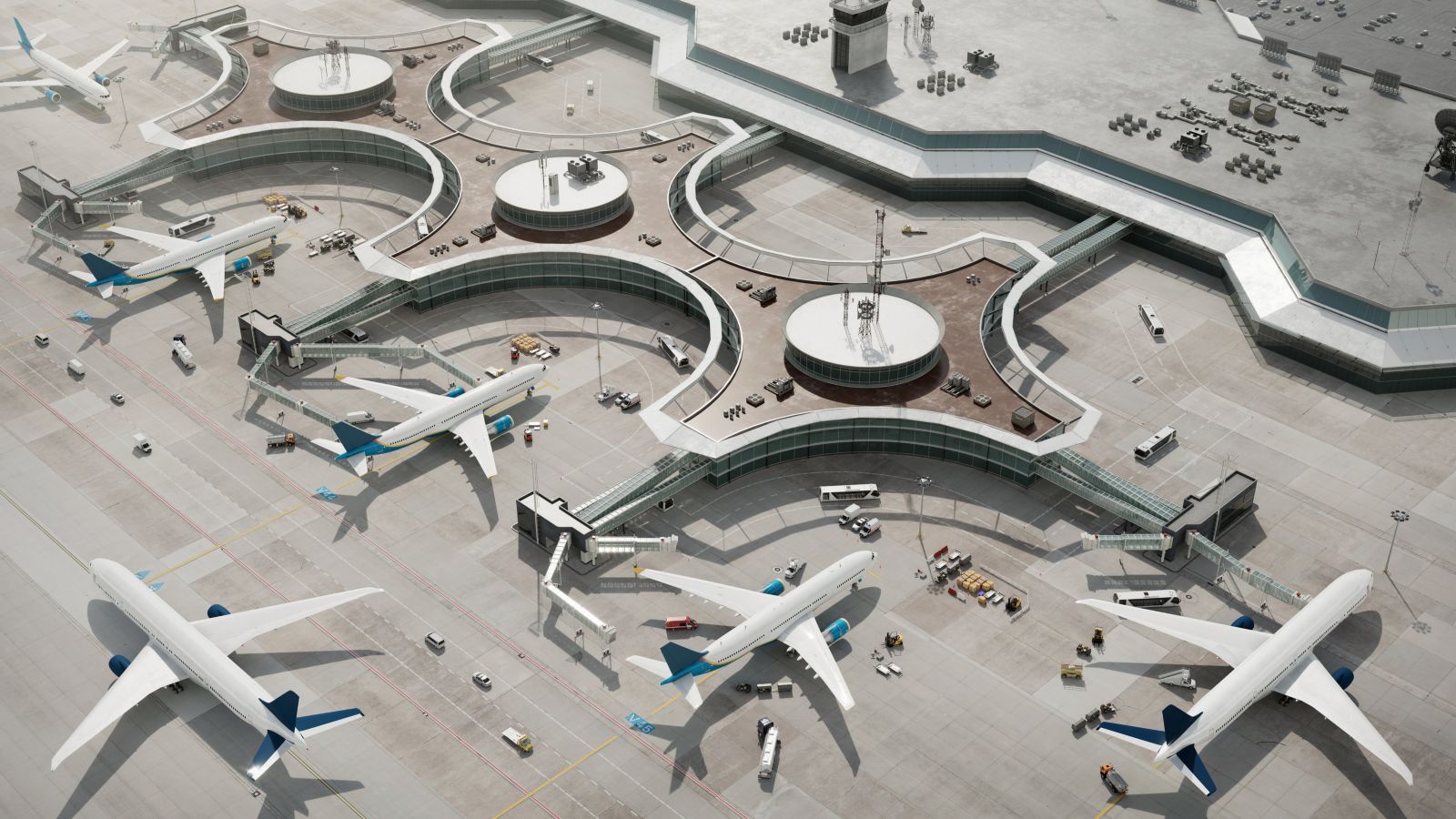 An aerial view showcasing commercial airplanes parked at a geometric airport terminal with ground support vehicles operating on the concrete tarmac.