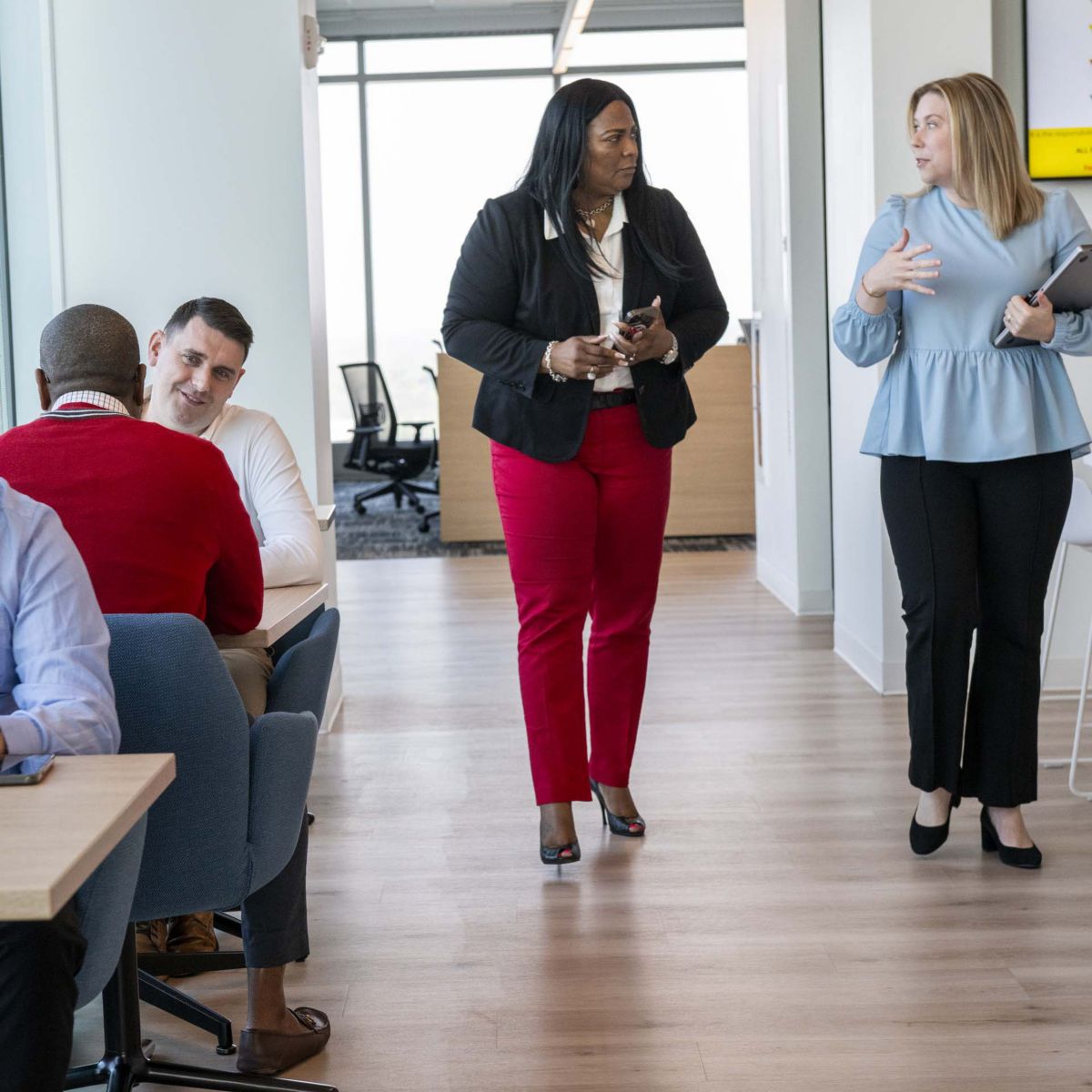 Diverse professionals collaborating in a modern open office, highlighting teamwork, productivity, and flexible workspace design in corporate environments.