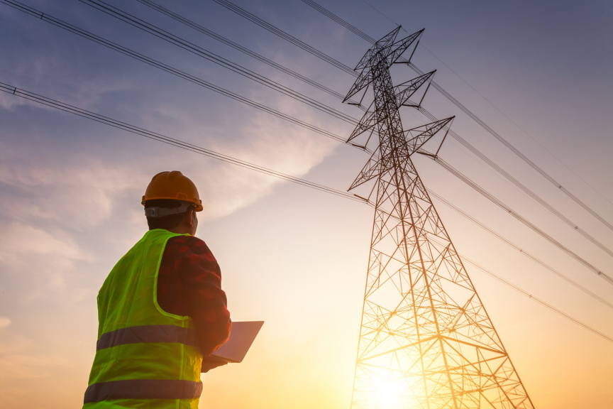 Asian Manager Engineering in standard safety uniform working inspect the electricity high voltage pole.