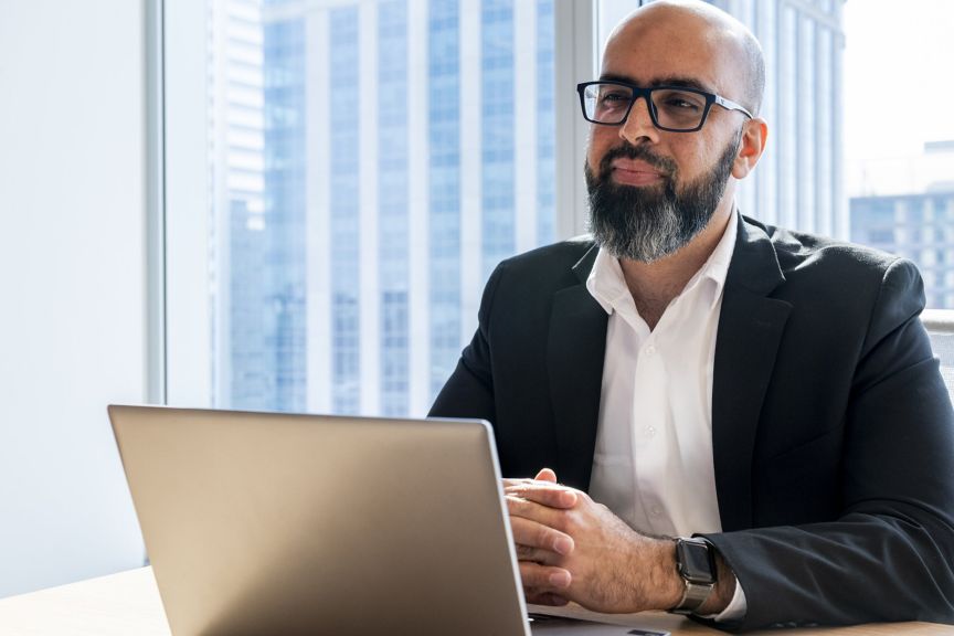 Business Professional Working on Laptop in Modern Office with City View
