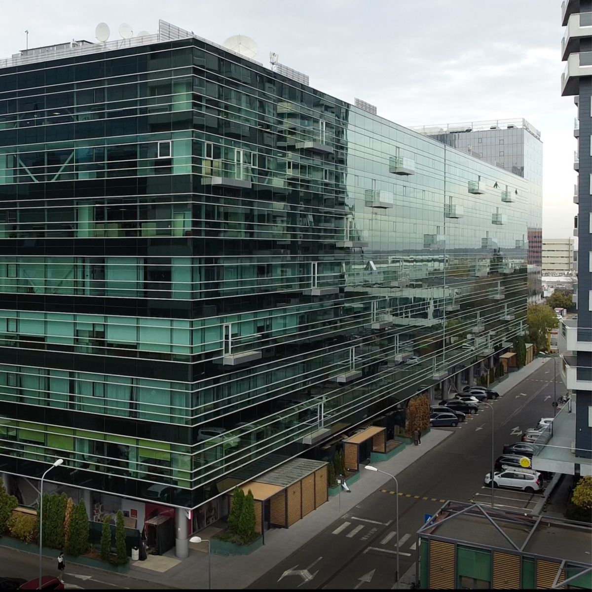 Sleek modern office HQ in Romania with glass facade, urban setting, and contemporary architecture—ideal for corporate and tech businesses.