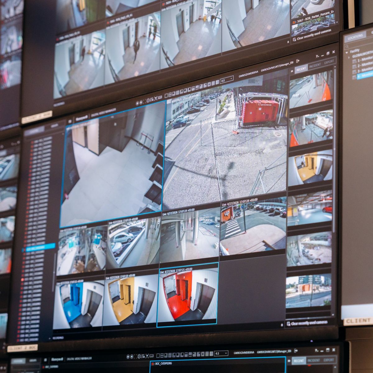 A comprehensive view of a multi-screen security wall displaying live surveillance footage from various cameras within a facility.