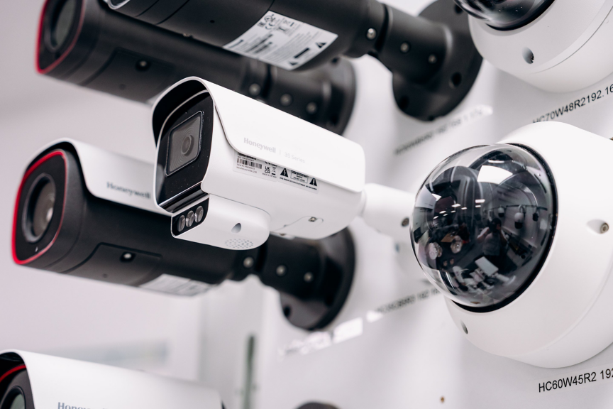 A selection of professional Honeywell security cameras mounted on a wall for display and demonstration purposes.