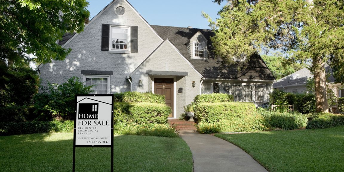 House exterior with a Home for Sale sign in the front yard