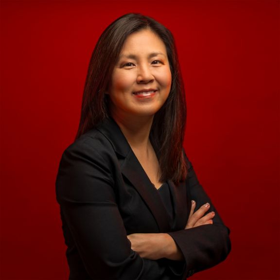 Corporate bio photo of Su-Ping Lu against a modern red background