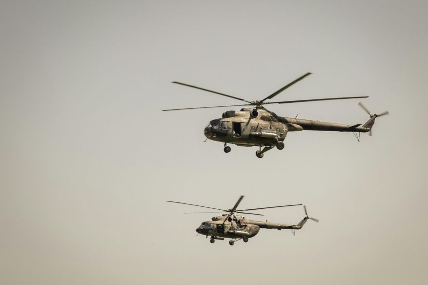 Two helicopters flying in formation against a clear sky, representing defence, aviation, mobility, and mission-critical operations.