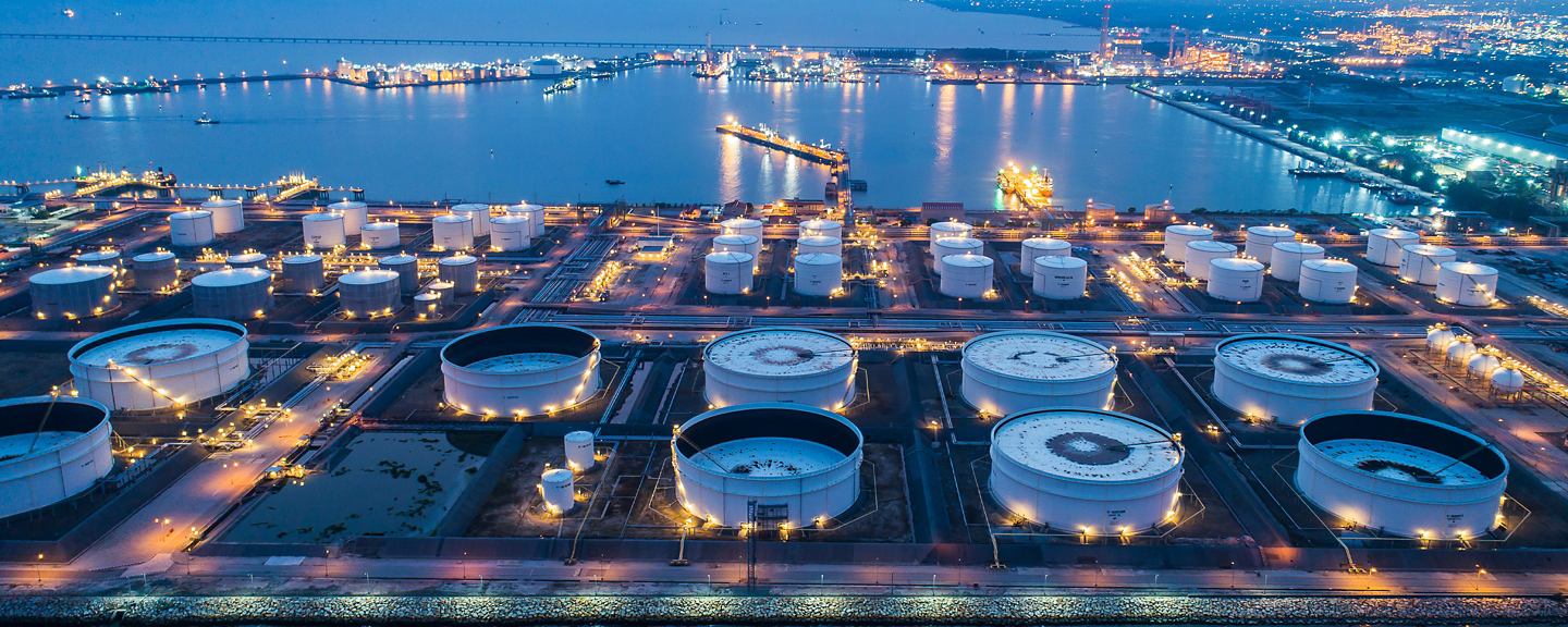 Aerial view or top view night light oil terminal is industrial facility for storage of oil and petrochemical. oil manufacturing products ready for transport and business transportation.