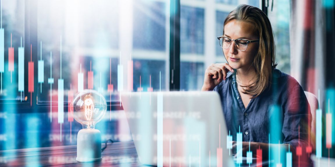 Young woman working at modern office.Technical price graph and indicator, red and green candlestick chart and stock trading computer screen background. Double exposure. Trader analyzing data