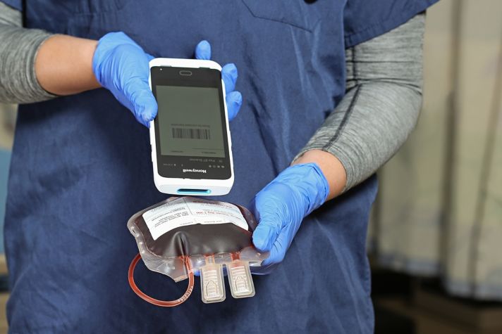 hands using a barcode scanner to scan a label