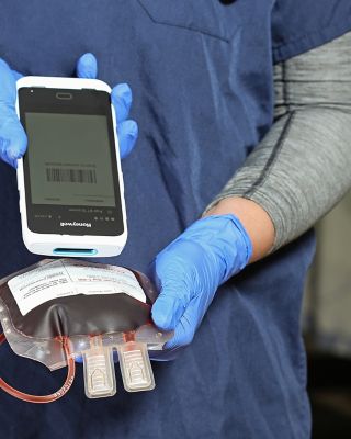 hands using a barcode scanner to scan a label