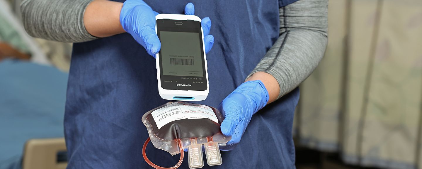 hands using a barcode scanner to scan a label