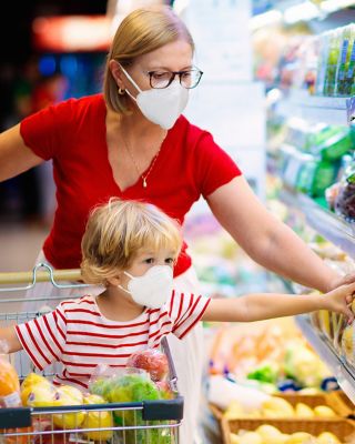 Woman grocery shopping  with her child