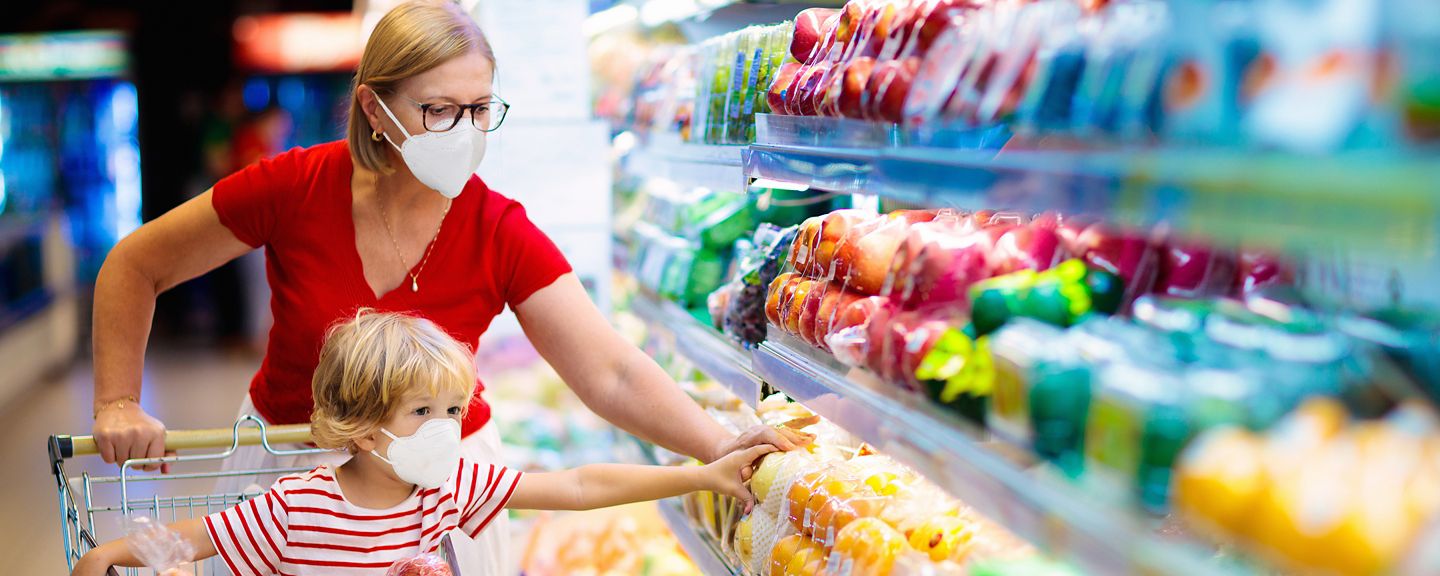 Woman grocery shopping  with her child