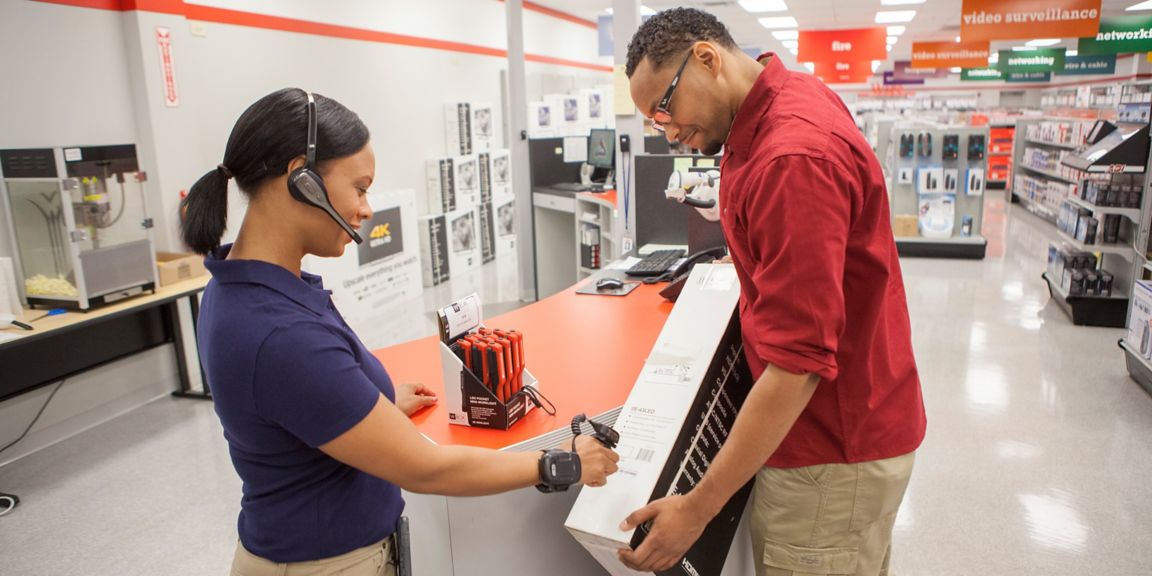 worker using a wearable scanner to scan a customer’s product 