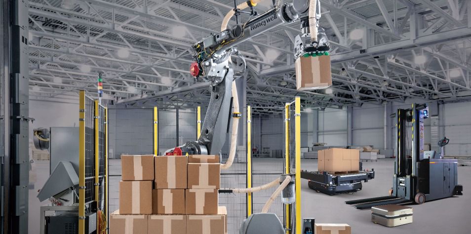 Boxes being lifted by machine in warehouse