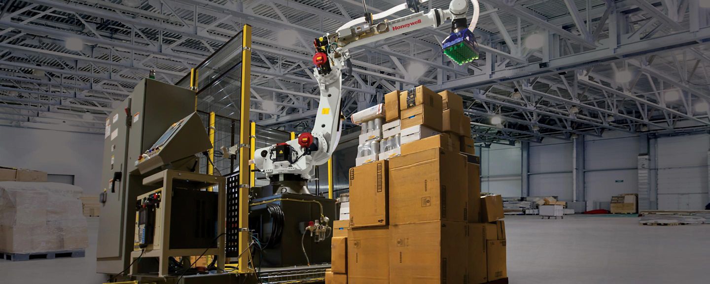 A mixed SKU depalletizer and an autonomous mobile robot move product in a distribution center