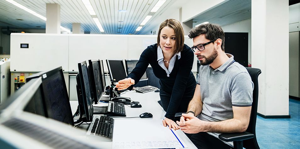 Two people analyzing lifecycle support services data