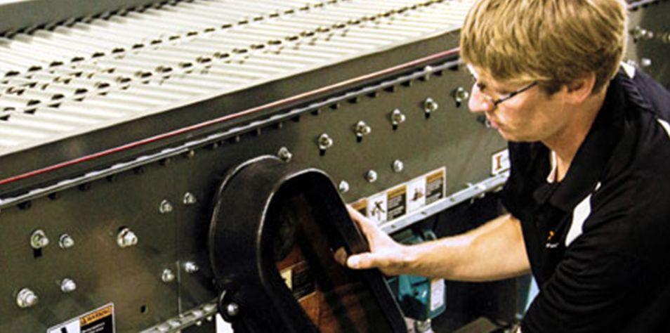 Man performing maintenance on conveyor