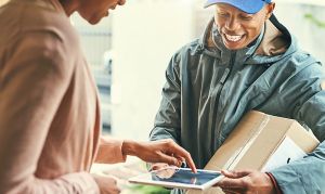 woman signing for receiving a package 
