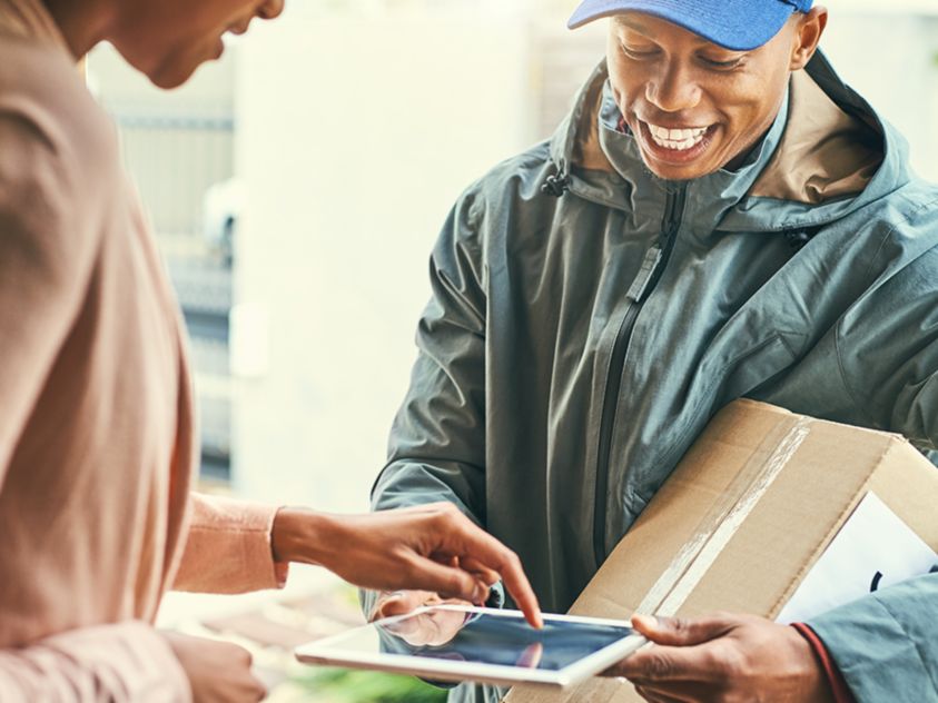 woman signing for receiving a package 