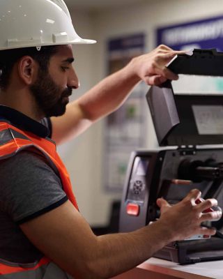 service worker wearing a helmet and fixing a device