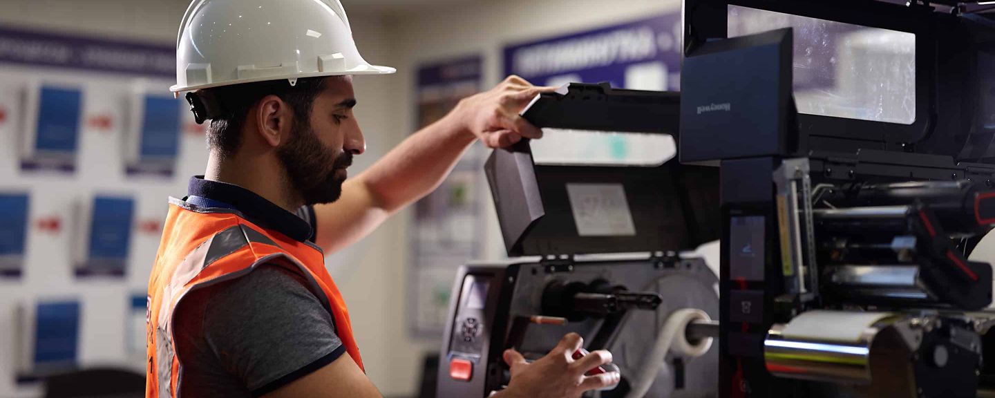 service worker wearing a helmet and fixing a device