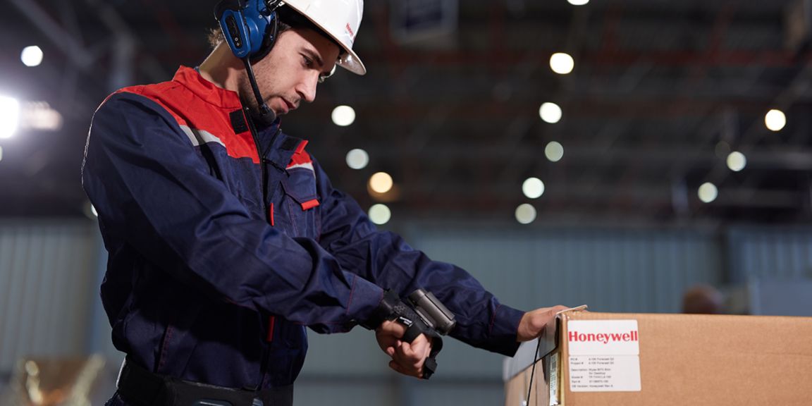 worker wearing wearable devices scanning a label on a package 