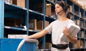 woman wearing headset in front of shelves