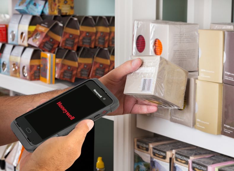 Cropped image of man's hand scanning product through mobile phone