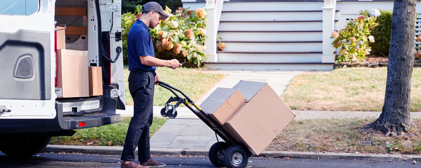 Courier delivering a package in front of a house