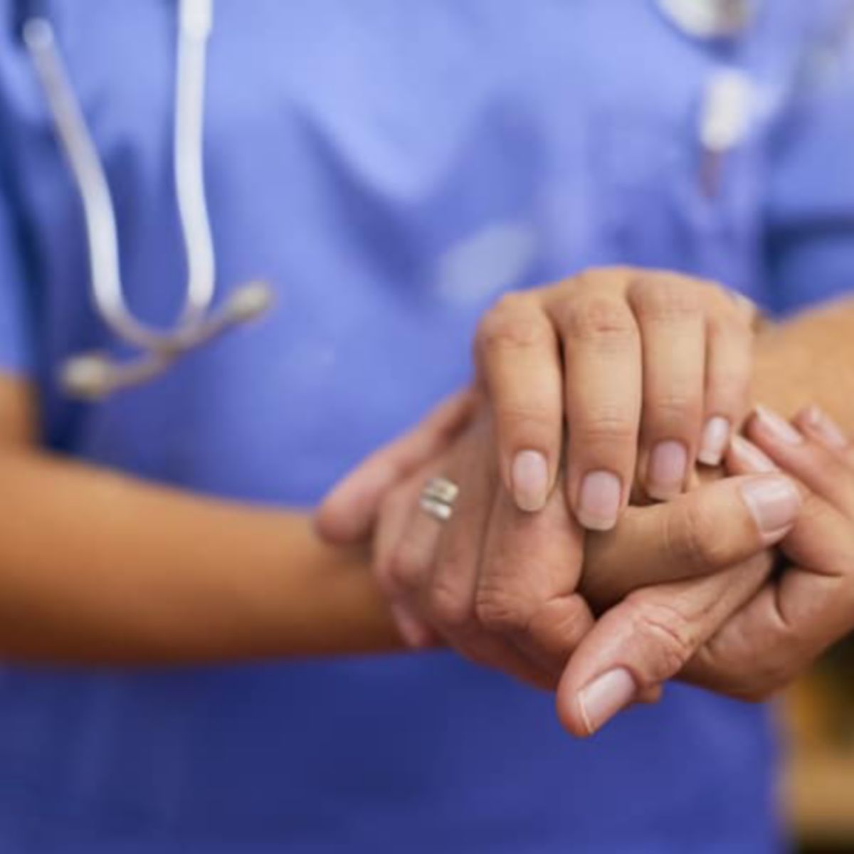 Cropped shot of a nurse holding a senior woman's hands in comfort
