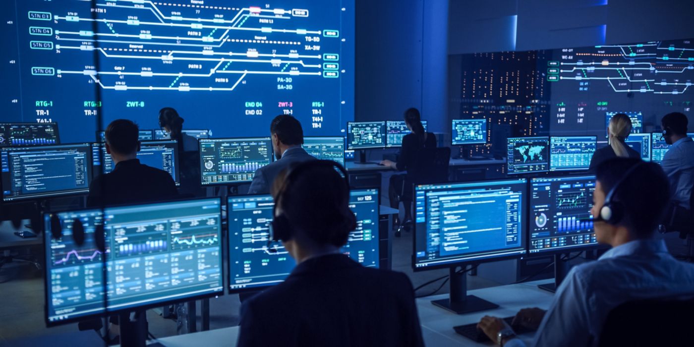 Team of Professional Computer Data Science Engineers Work on Desktops with Screens Showing Charts, Graphs, Infographics, Technical Neural Data and Statistics. Low Key Control and Monitoring Room.