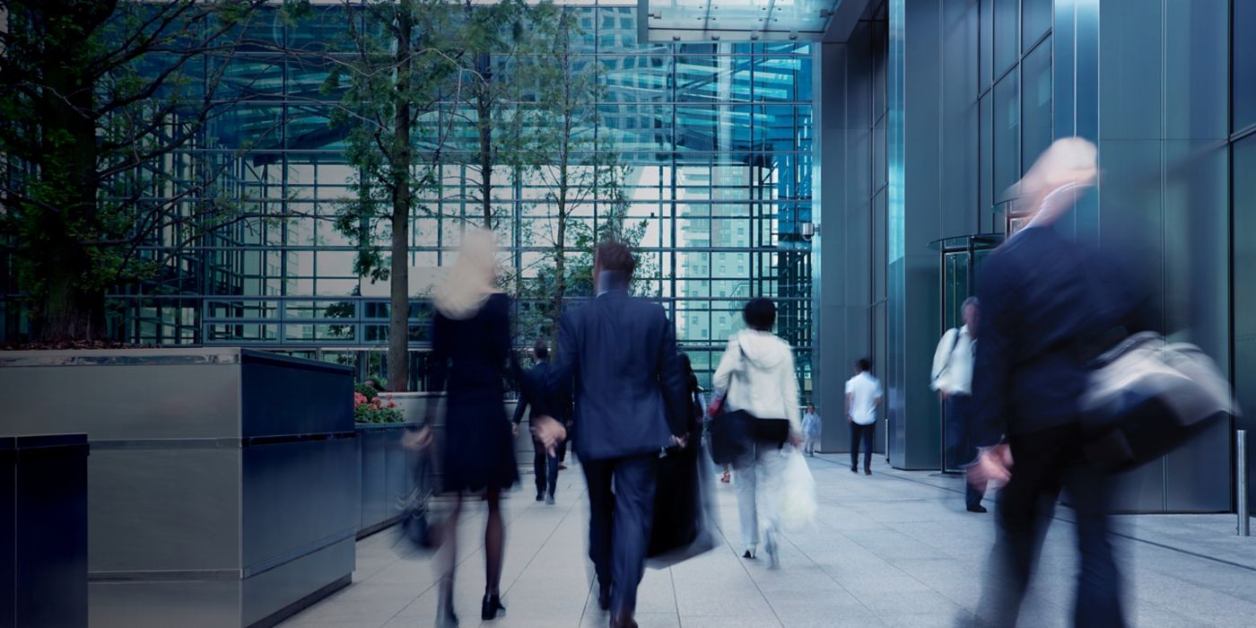 People walking into office building.