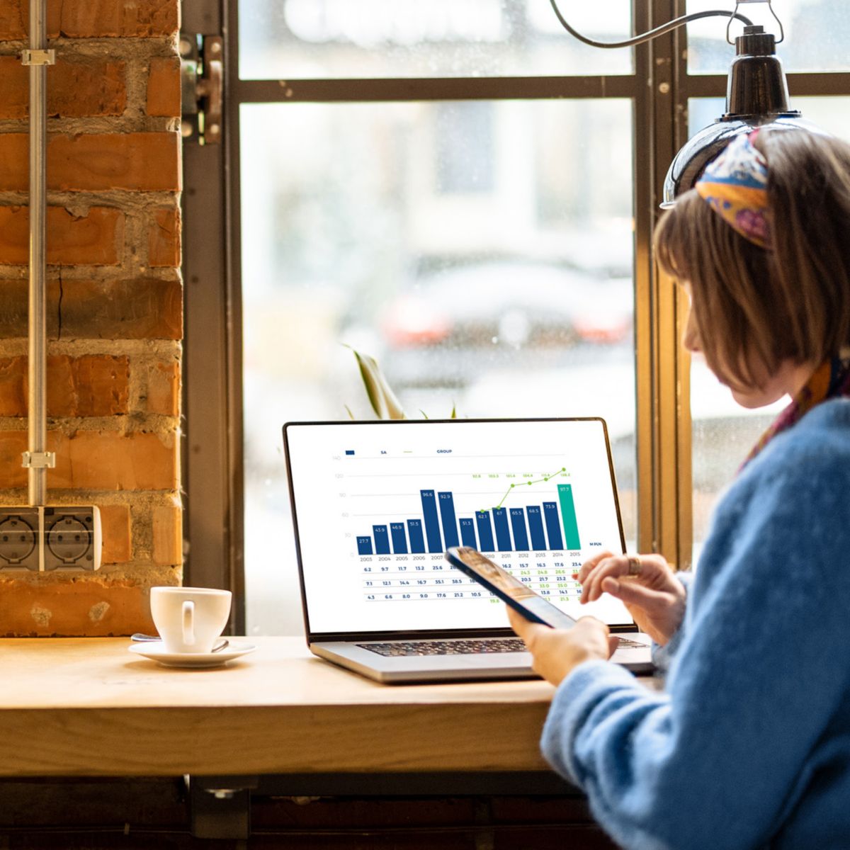 Female in front of laptop in modern coffee shop