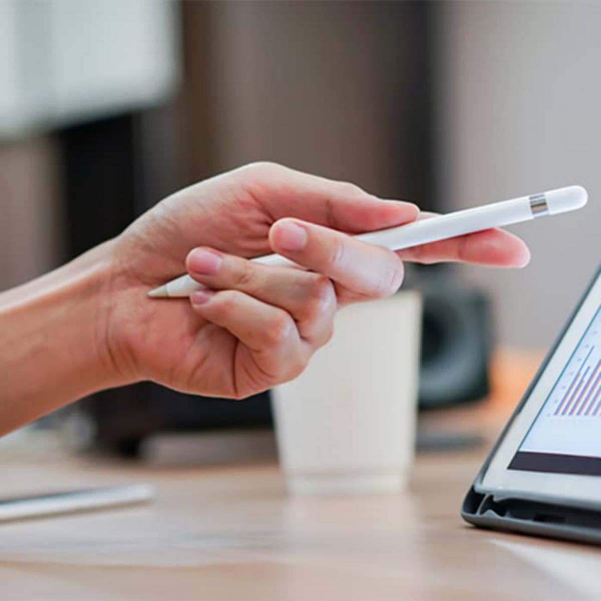 close up salesman employee hand using stylus pen to pointing on tablet screen to show company profit monthly in the meeting event at conference room , business strategy concept