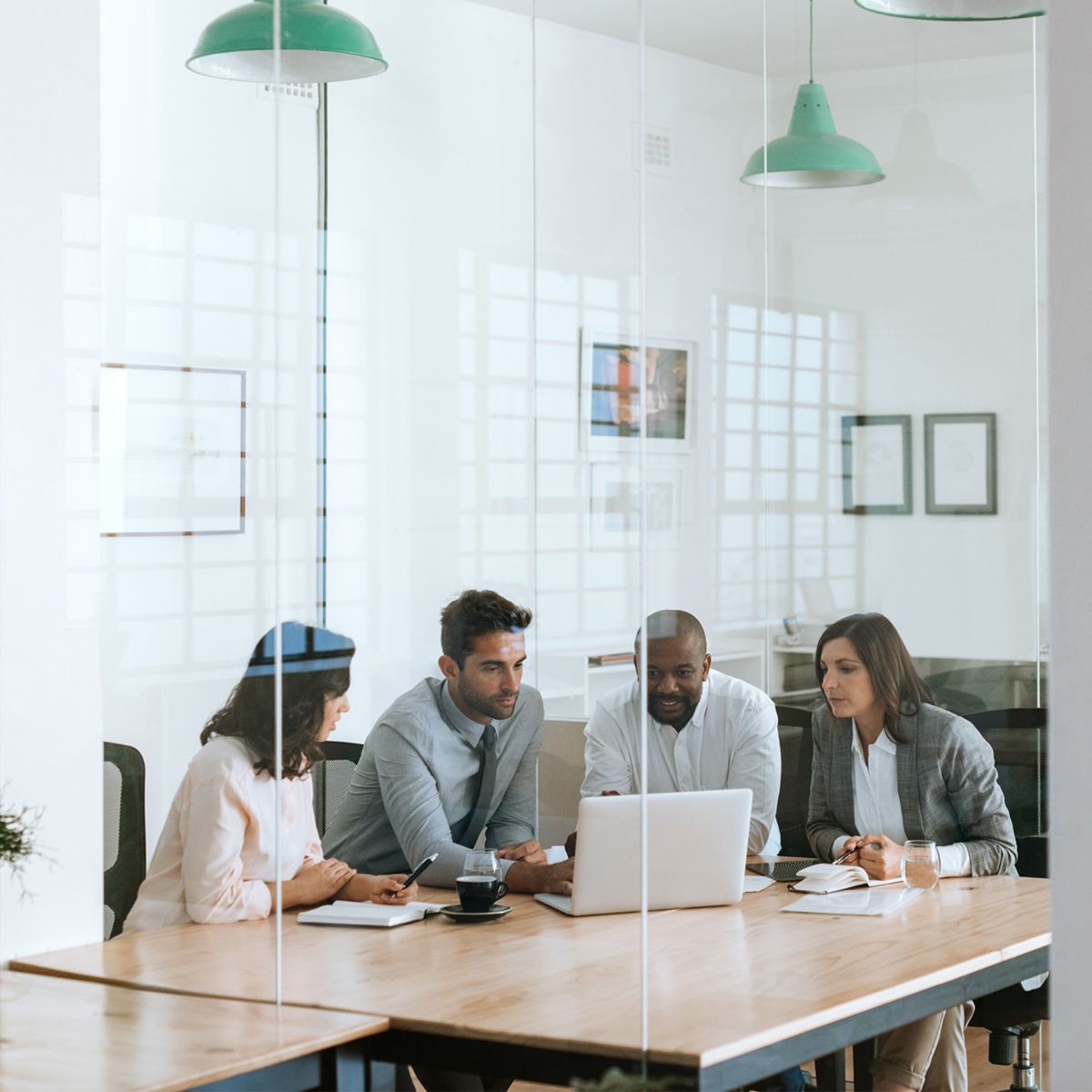 Employees inside office building conference room.