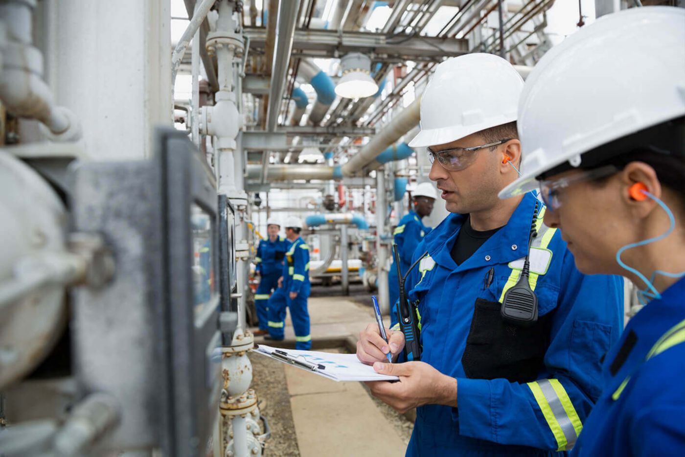Two workers checking equipment