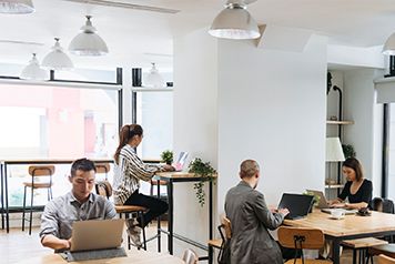 Shot of a young businessman using a laptop at his desk in a modern office