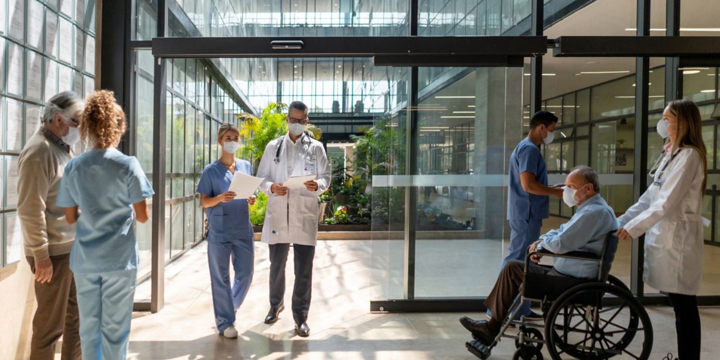 People walking in and out of the hospital - Healthcare concepts