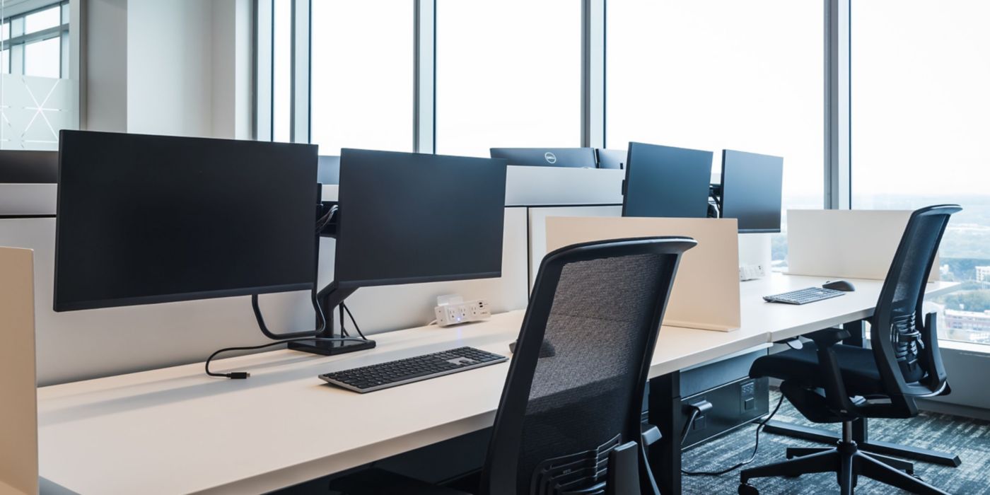 Workspace areas at the Honeywell headquarters. Two desks are shown with computer monitors and keyboards.