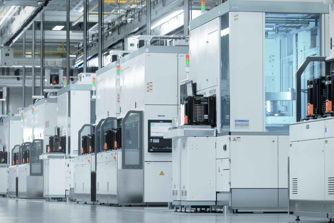 A row of advanced manufacturing machines in a modern facility, showcasing technological innovation and efficiency.