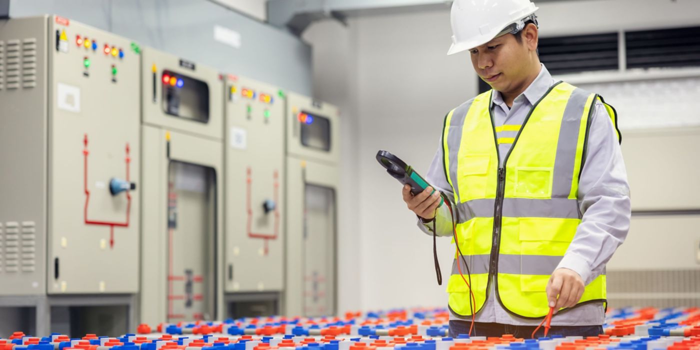 An engineer monitoring system operations in a control room environment.