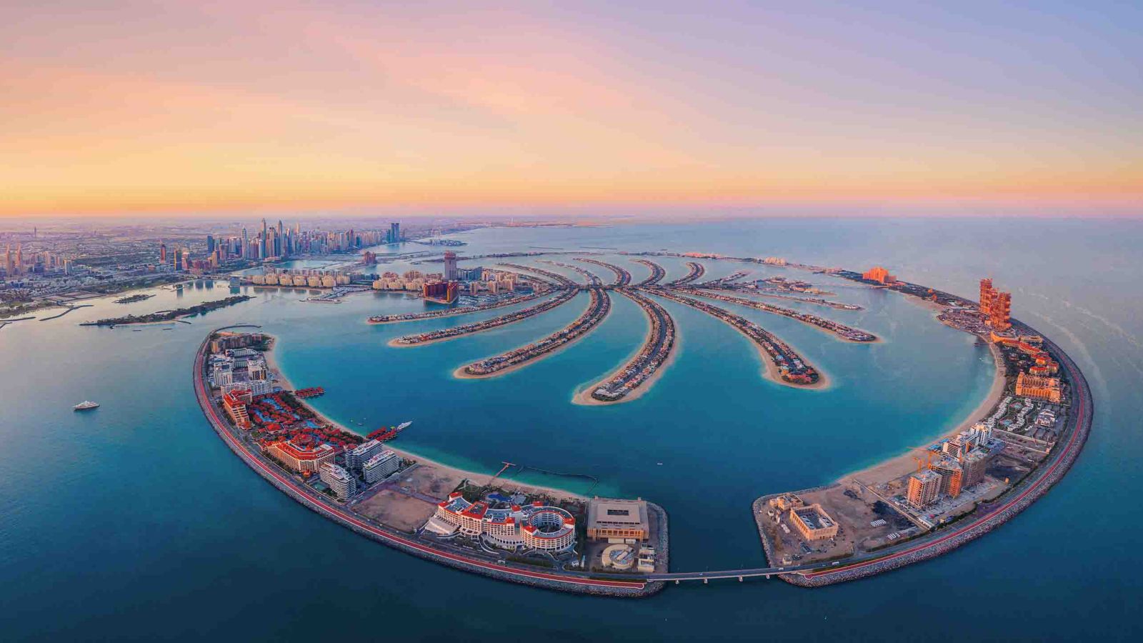 Discover Palm Jumeirah, Dubai’s iconic man-made island. Stunning aerial views showcasing luxury resorts, coastline, and world-famous architecture.